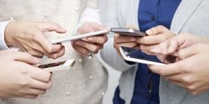 small group of people using cellphones together.